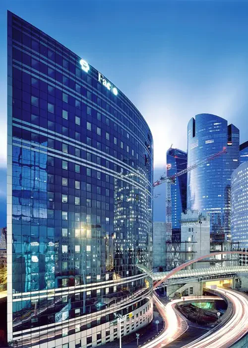 Glass office towers and elevated roads at dusk